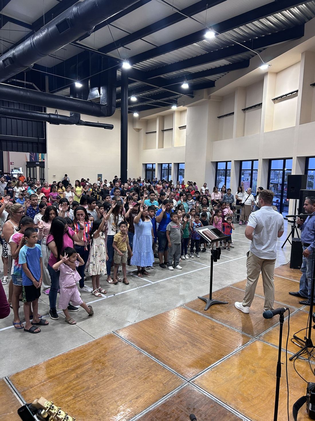 Children and families streaming forward to the front during an altar call in Reynosa