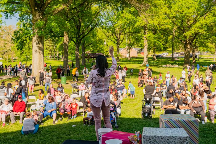 Families gathered on a park lawn at an outreach in McKeesport